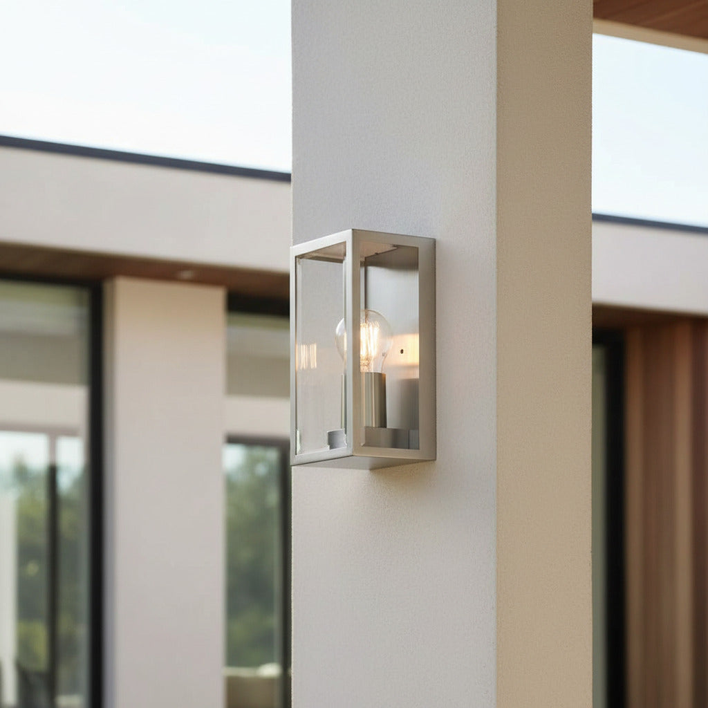 stainless steel outdoor wall sconce light on a thin wall pillar