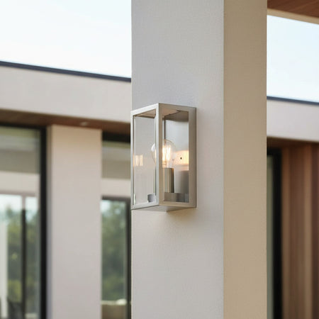 stainless steel outdoor wall sconce light on a thin wall pillar