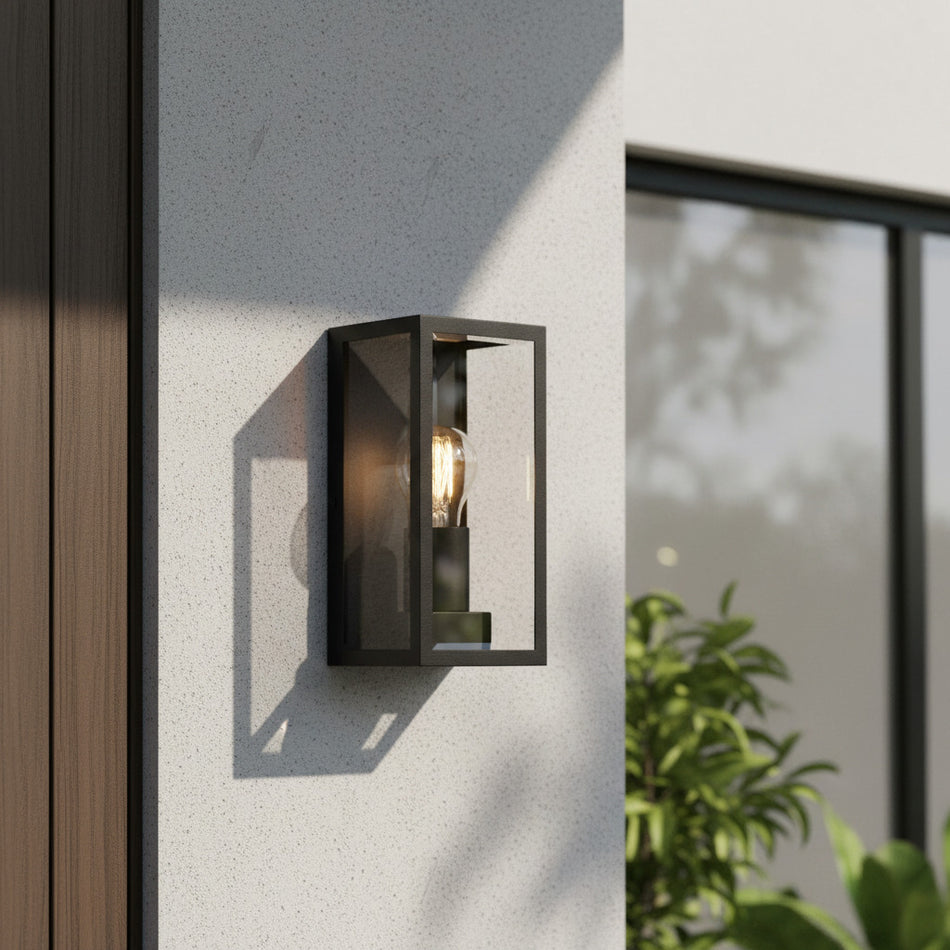 black outdoor wall sconce mounted next to a front door 