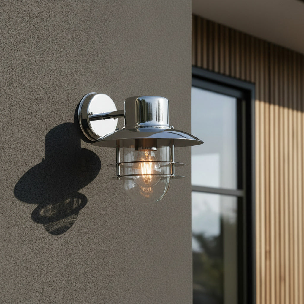 stainless steel exterior lantern sconce mounted on the wall outside a modern house 