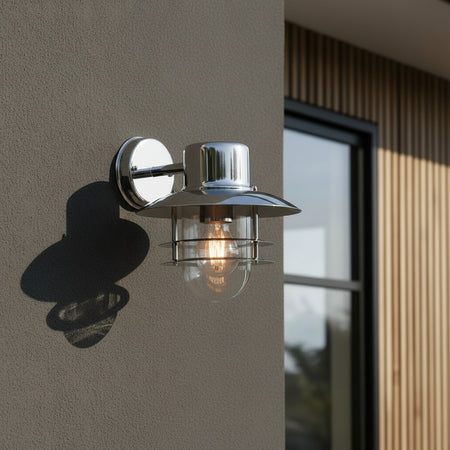 stainless steel exterior lantern sconce mounted on the wall outside a modern house 