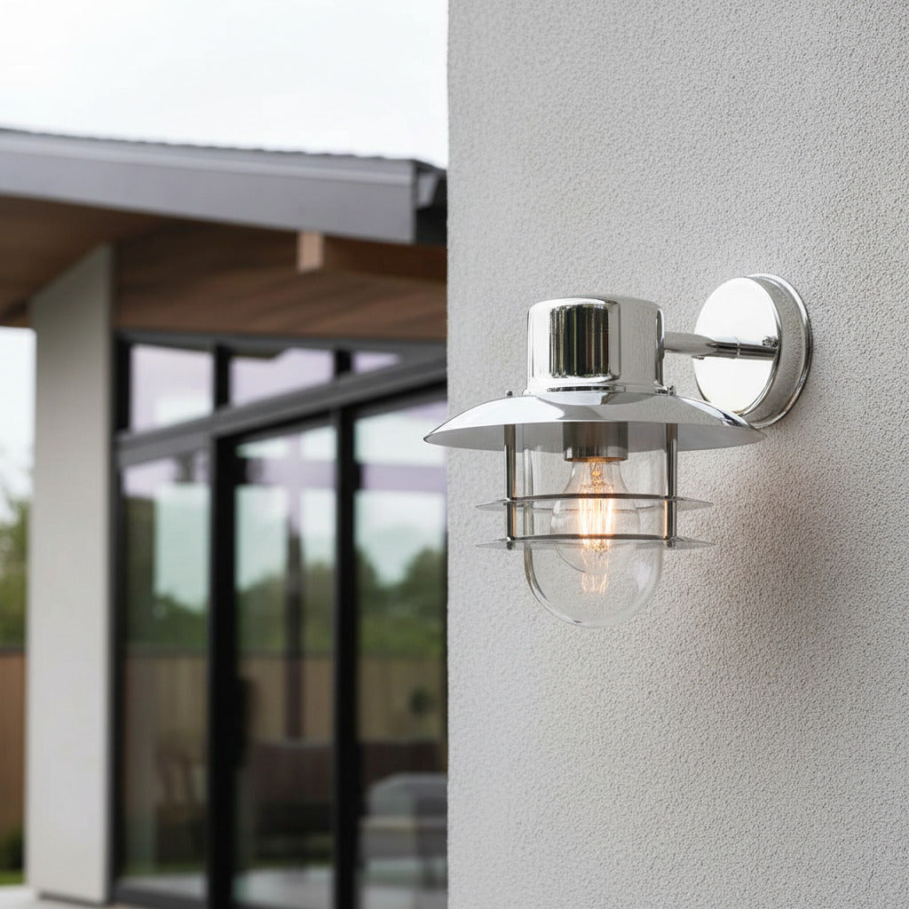 stainles steel exterior lantern sconce installed on a textured exterior wall 