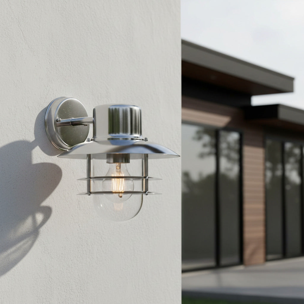 stainless steel exterior lantern sconce mounted on a white exterior wall 
