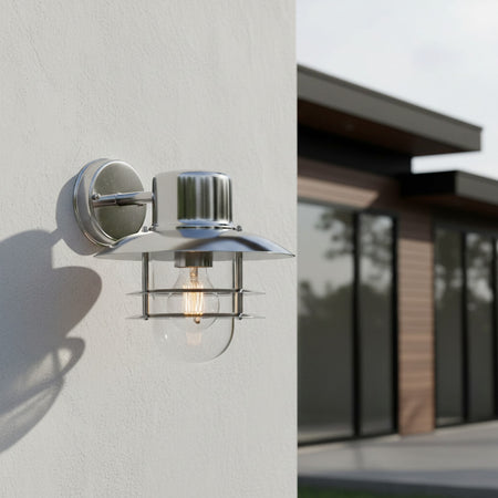 stainless steel exterior lantern sconce mounted on a white exterior wall 