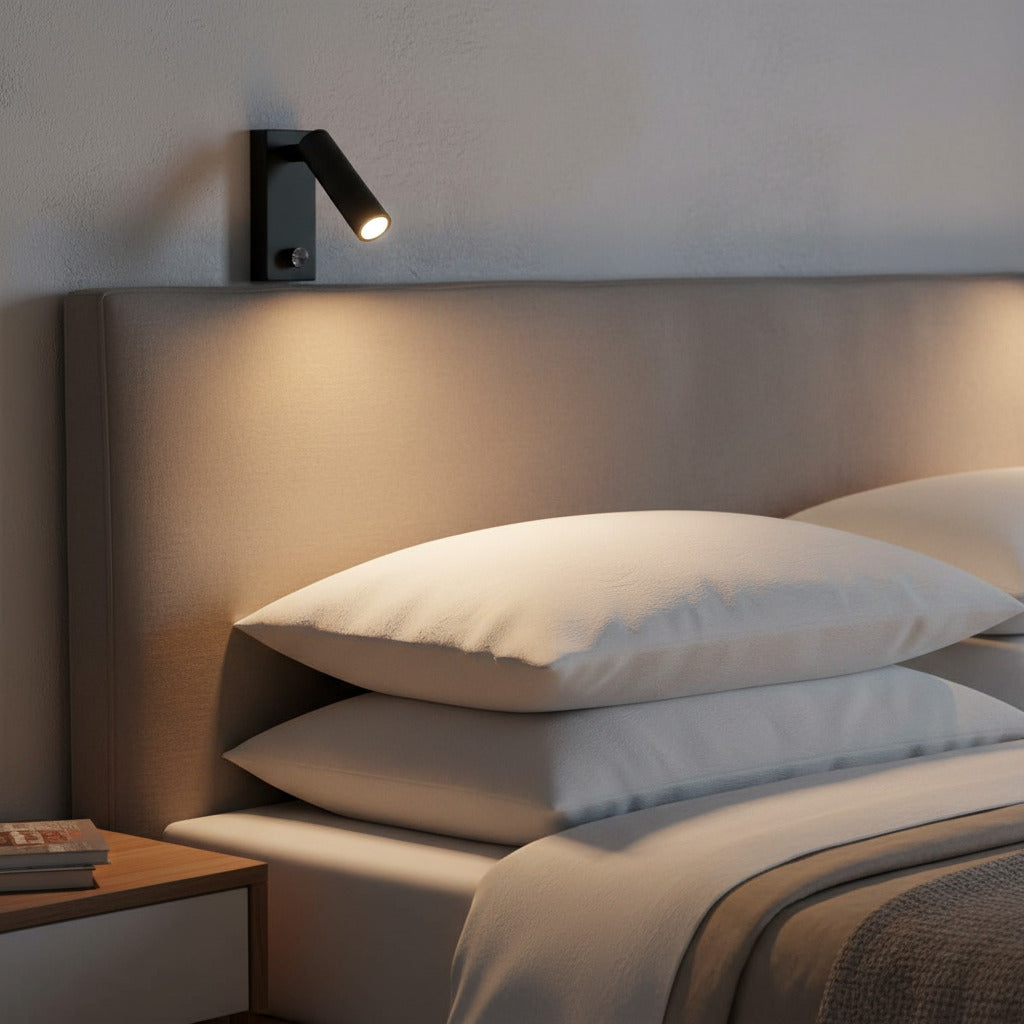 black dimmable bedside reading lamp mounted on the wall over a bed