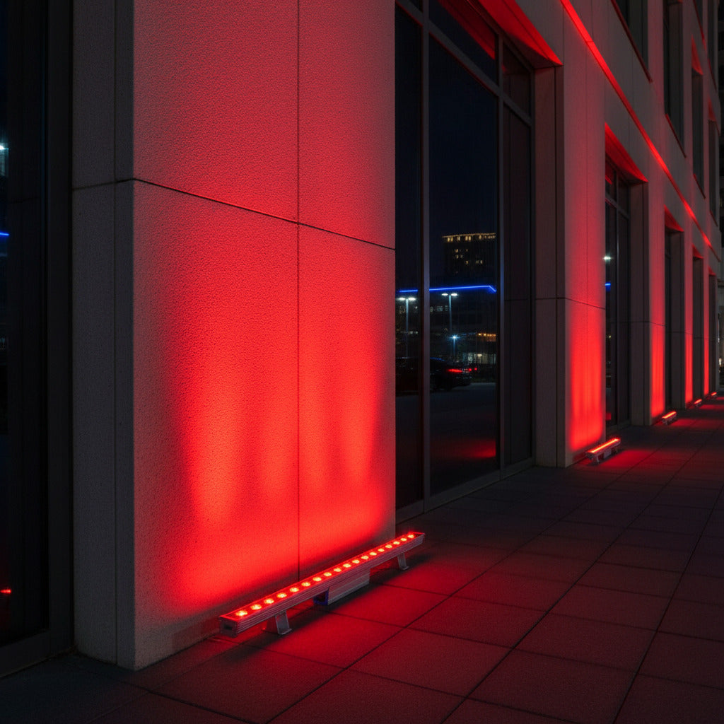 Red outdoor wall grazer light shining up the exteiror of a commercial building