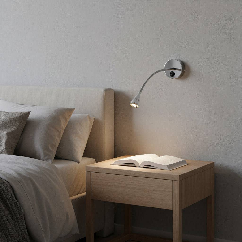silver flexible reading lamp mounted on the wall next to the bed and over a bedside table in a modern room 