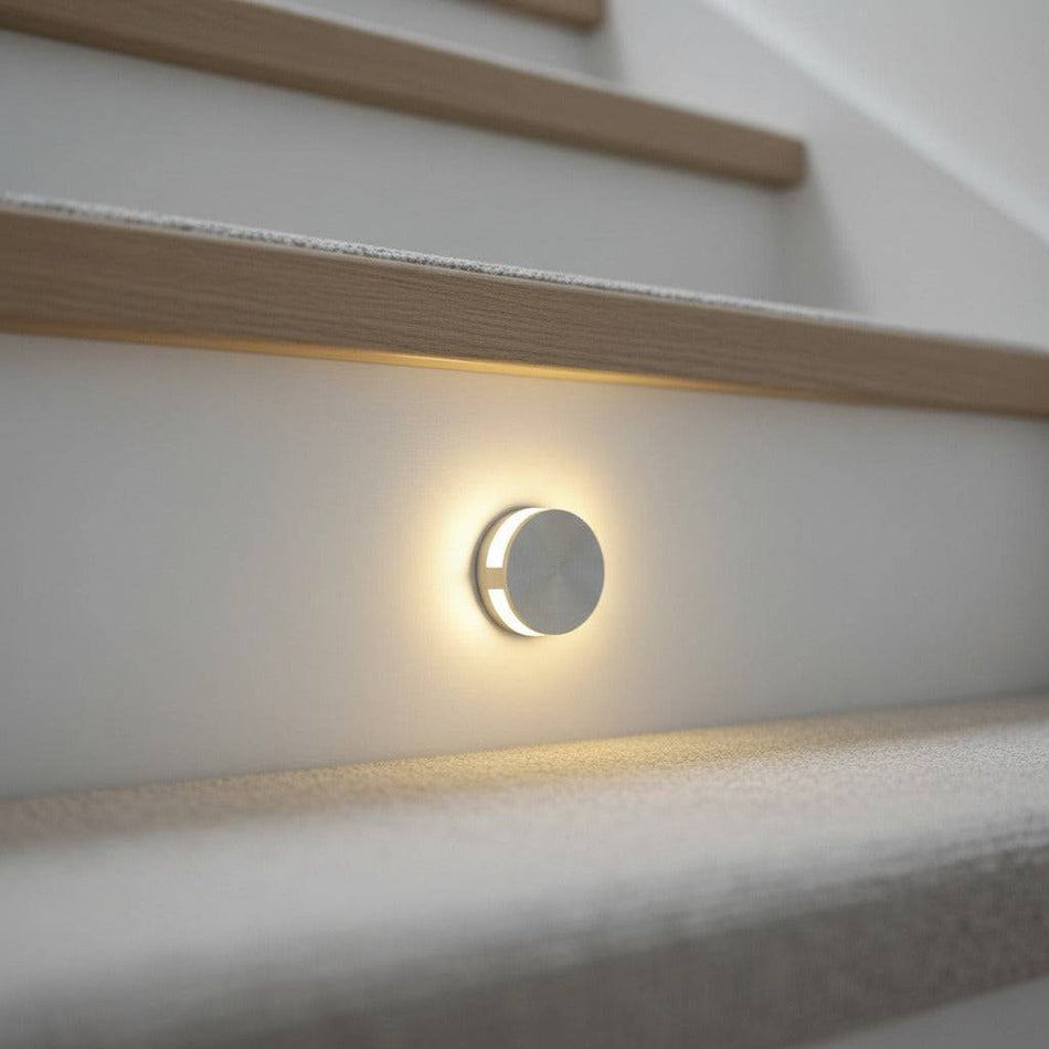 silver interior step light mounted on a stair riser