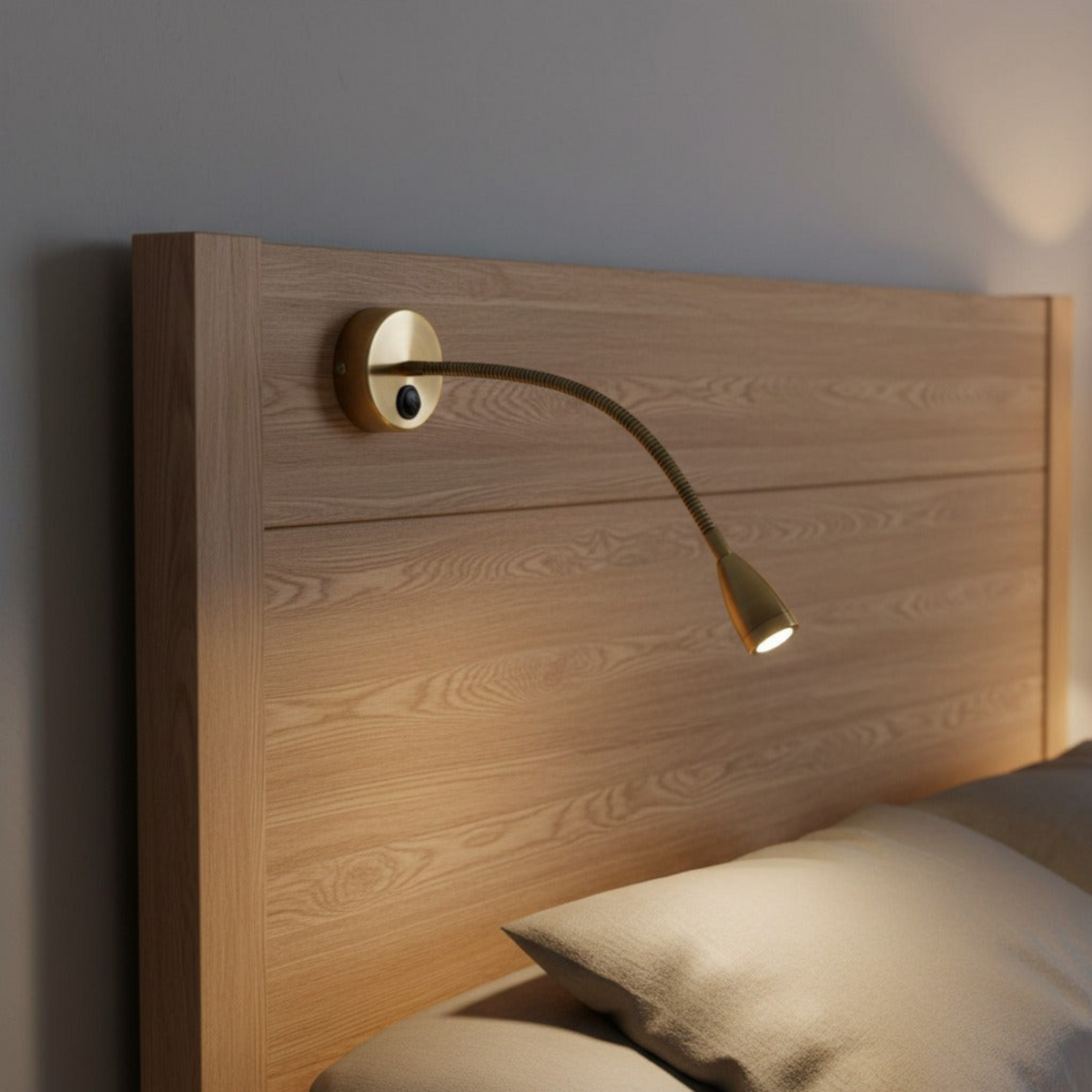 antique flexible bedside reading light mounted over a bed