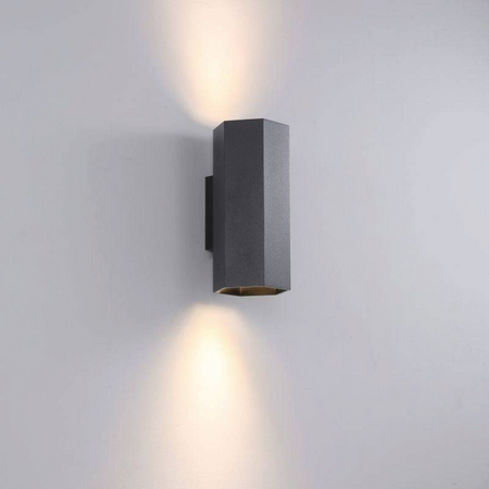 Ultra Beam Lighting Ltd black hexagonal LED wall light casting warm up and down beams on a grey interior wall