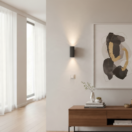 Ultra Beam Lighting Ltd hexagonal black wall light casting warm up and down beams on a modern living room wall
