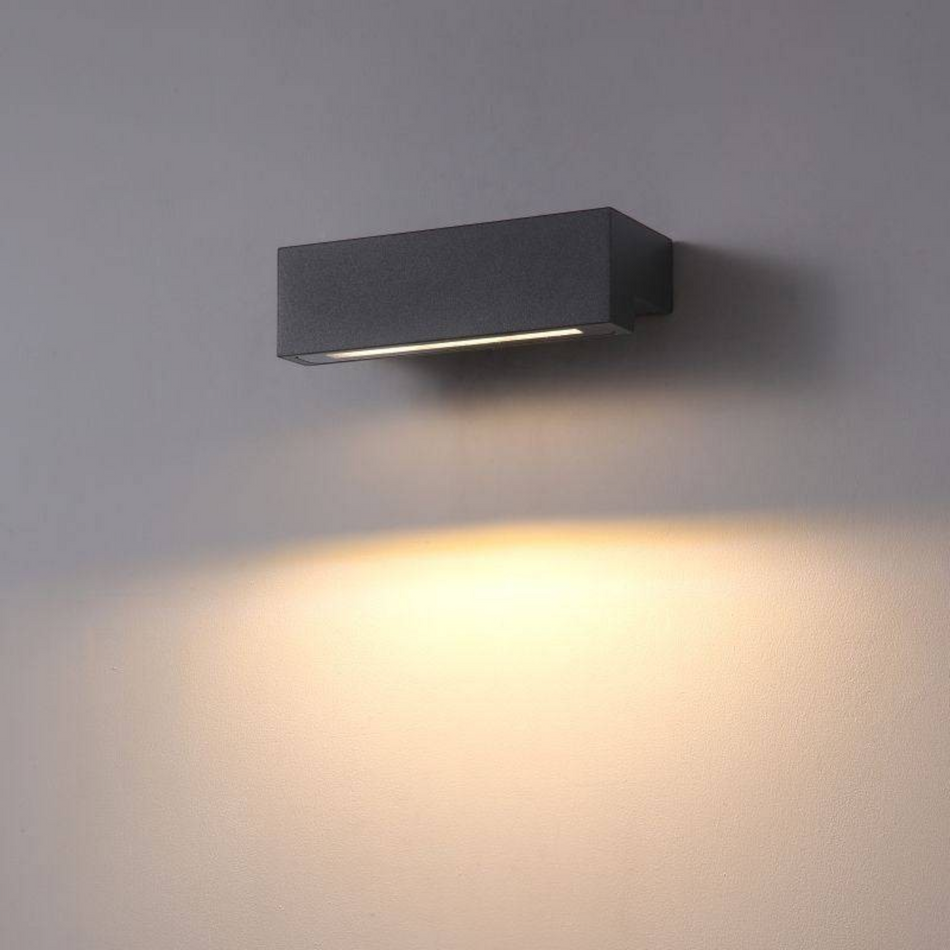 Ultra Beam Lighting Ltd 9W black LED outdoor wall light casting a warm downward beam on a grey wall