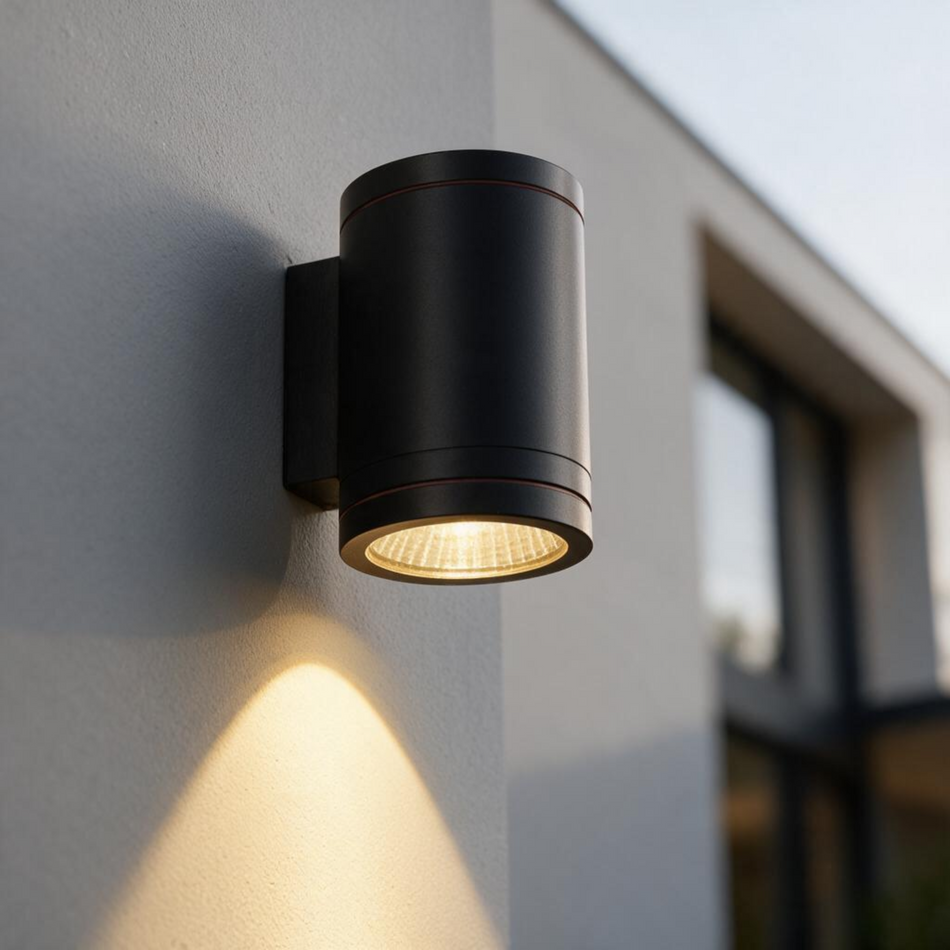 Ultra Beam Lighting Ltd 12W LED black outdoor wall downlight casting a focused beam on a modern exterior wall