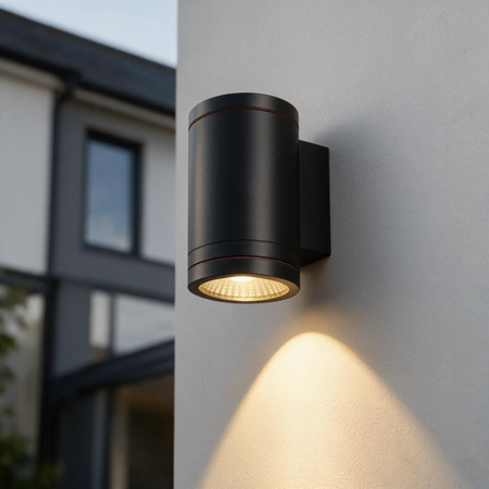 Ultra Beam Lighting Ltd 12W LED black outdoor wall downlight mounted on a white wall casting a focused downward beam.