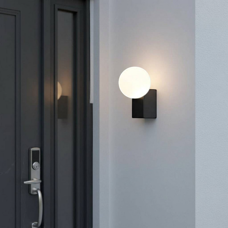 Ultra Beam Lighting Ltd 6W LED outdoor wall globe light with a modern black finish mounted by a front entrance door.