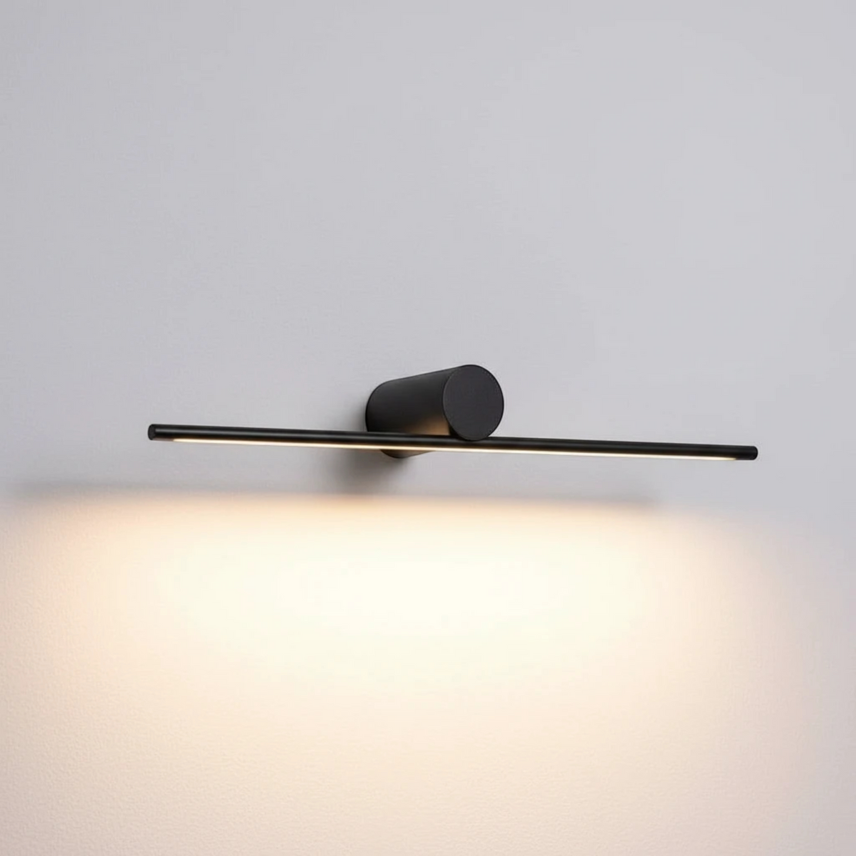 Ultra Beam Lighting Ltd 600mm matte black LED picture light with a minimalist cylindrical wall mount and slim bar.