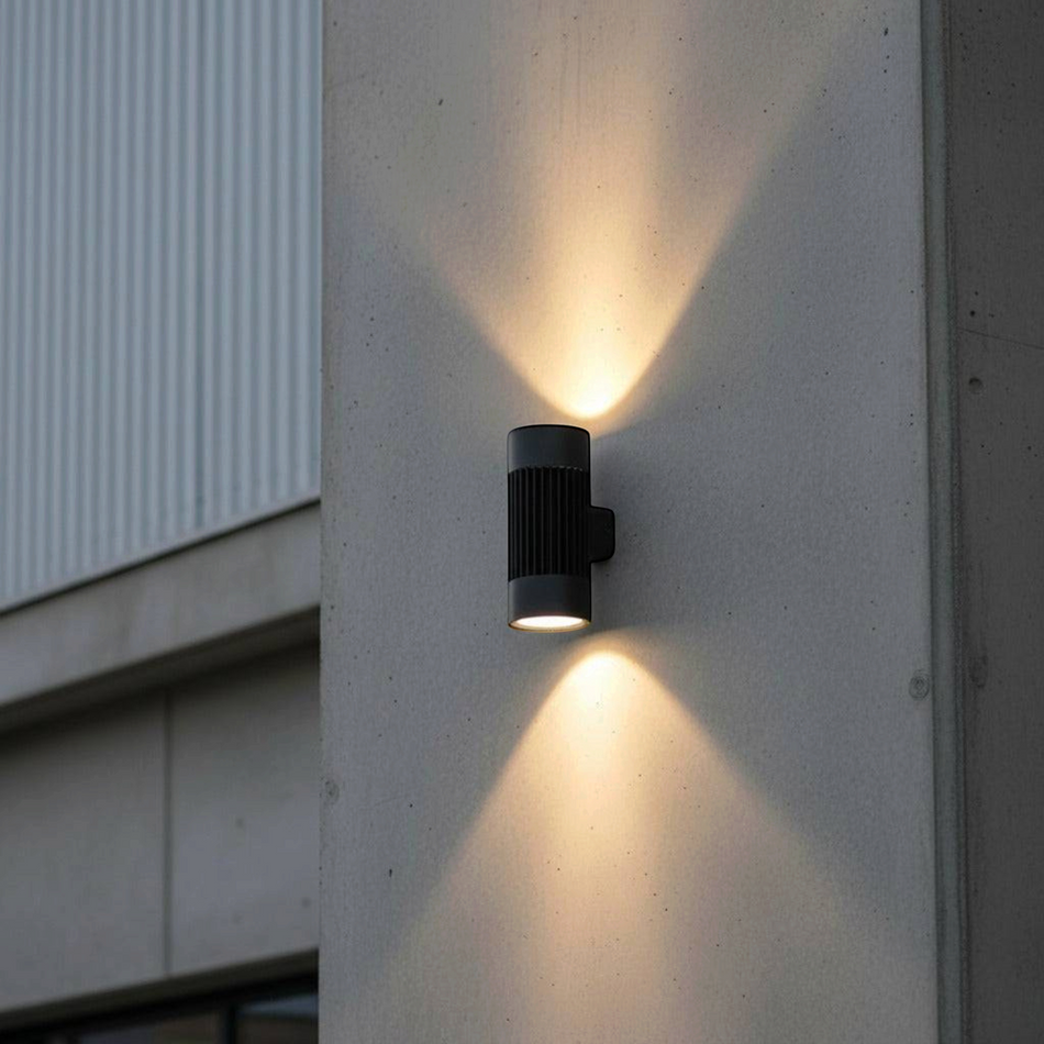 Ultra Beam Lighting Ltd 40W black LED exterior wall light casting vertical warm white beams on a concrete facade