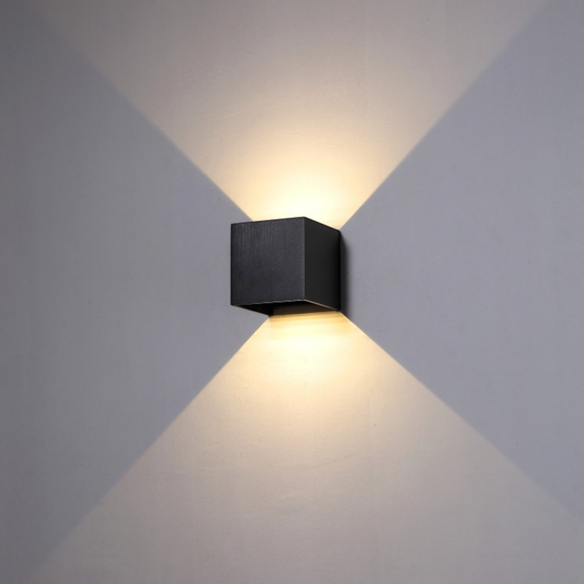 Ultra Beam Lighting Ltd 6 watt square black LED outdoor wall light with up and down beam effect on a grey wall