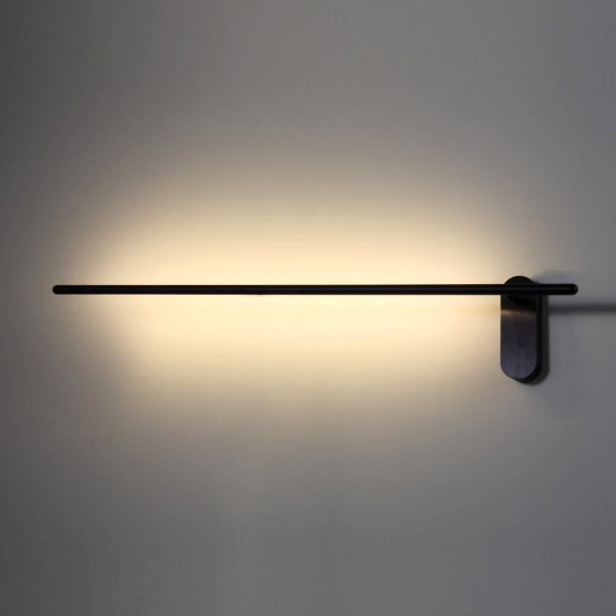 Ultra Beam Lighting Ltd 10W LED black wall light with horizontal bar design creating a warm halo wash effect