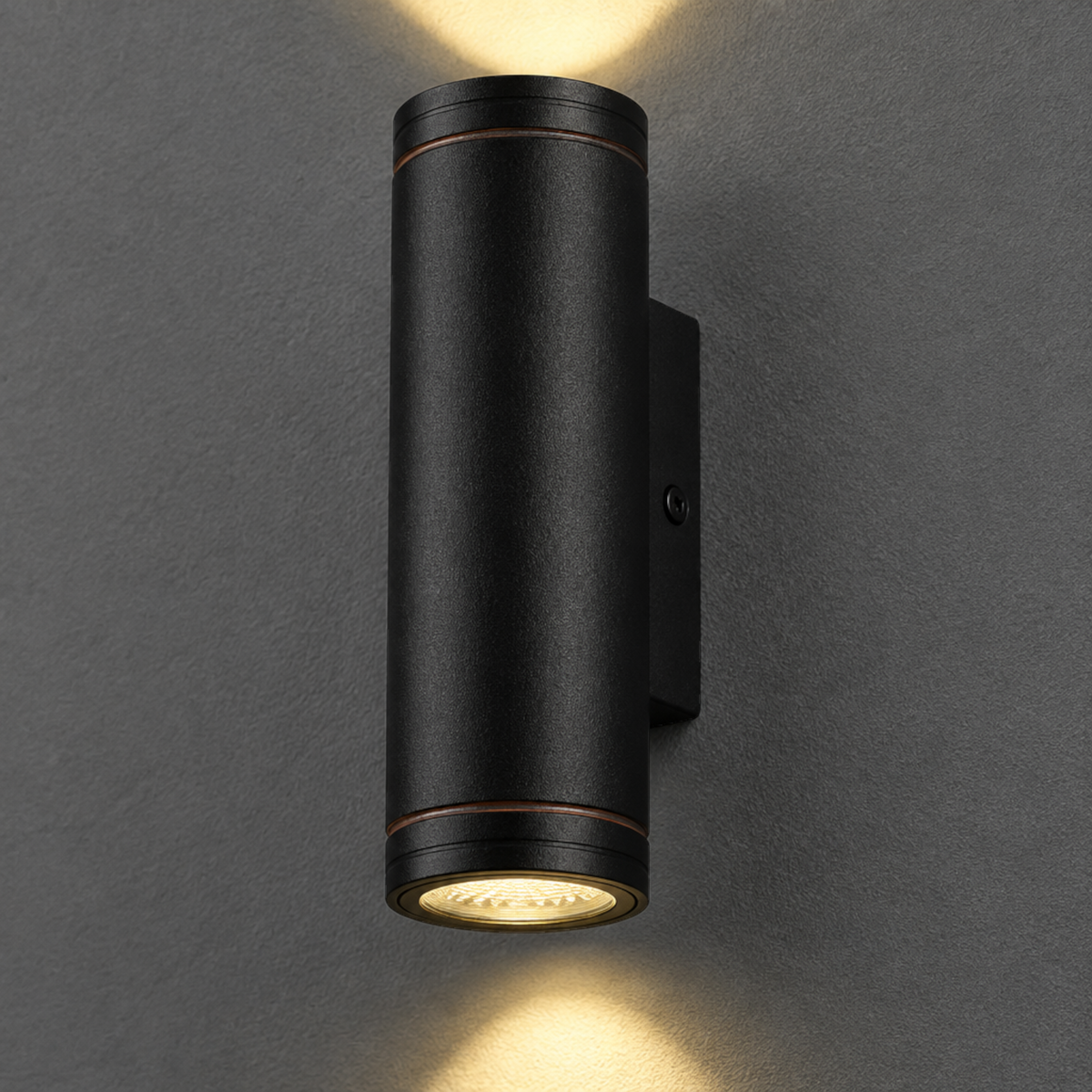 Ultra Beam Lighting Ltd 12W LED black outdoor up and down wall light with dual beams on a grey wall