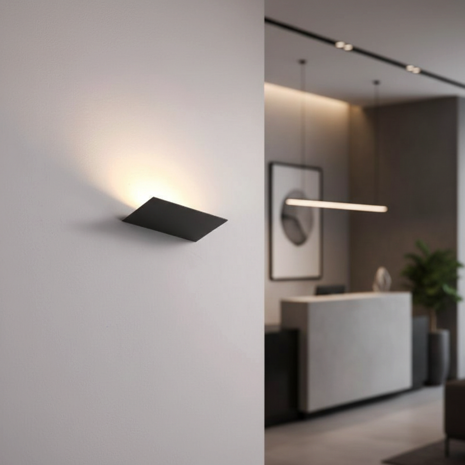 Ultra Beam Lighting Ltd 12W LED black wall uplighter casting a warm white beam on a modern interior wall
