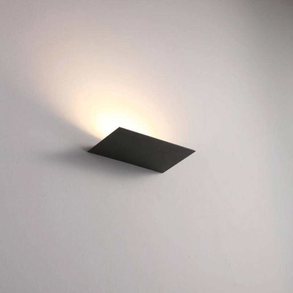 Ultra Beam Lighting Ltd 12W black LED wall uplighter casting a warm white beam on a minimalist interior wall