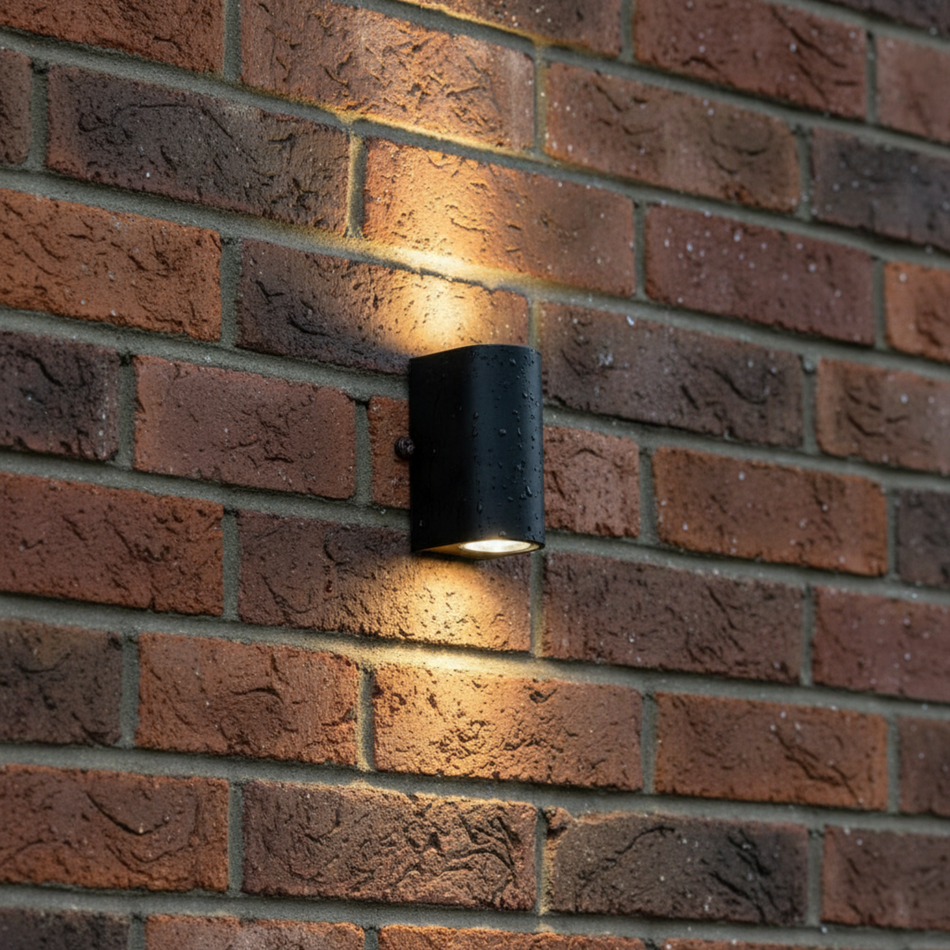 Ultra Beam Lighting Ltd black cylindrical LED outdoor up down wall light mounted on a red brick wall