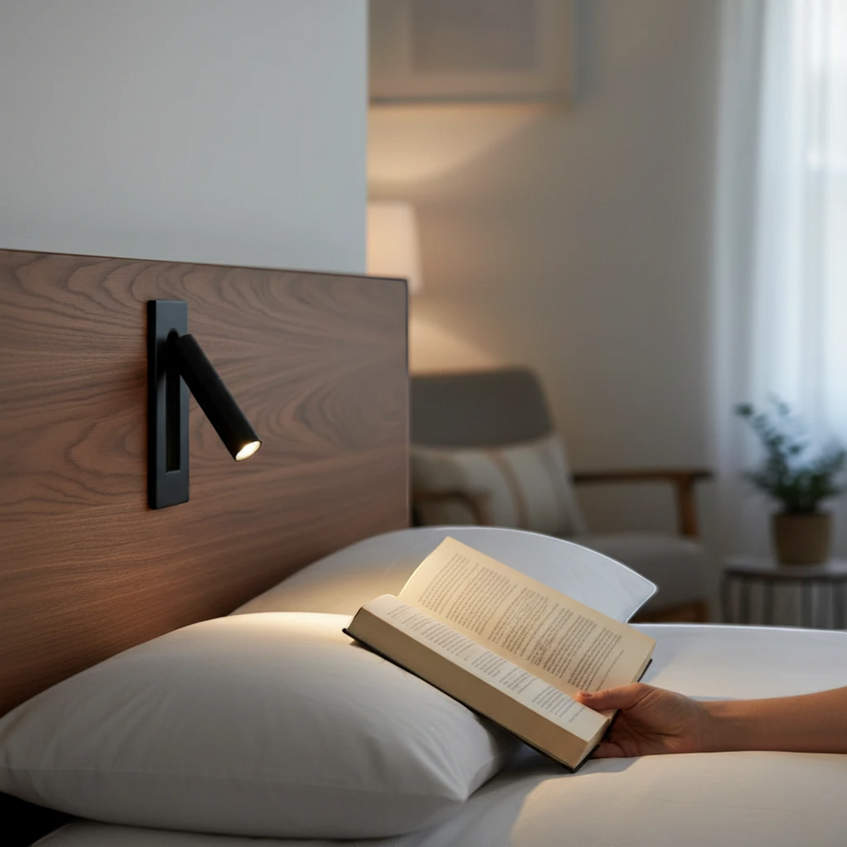Ultra Beam Lighting Ltd black recessed adjustable LED reading wall light mounted on a wooden headboard above a bed.