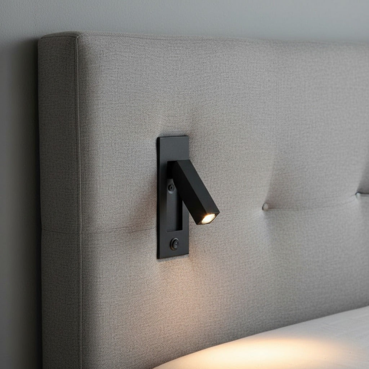 Ultra Beam Lighting Ltd black recessed reading light with adjustable arm mounted on a grey upholstered headboard