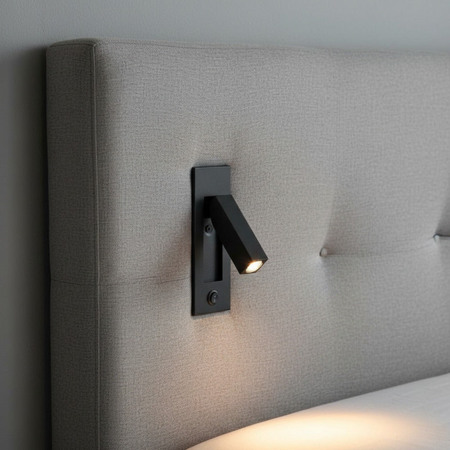 Ultra Beam Lighting Ltd black recessed reading light with adjustable arm mounted on a grey upholstered headboard