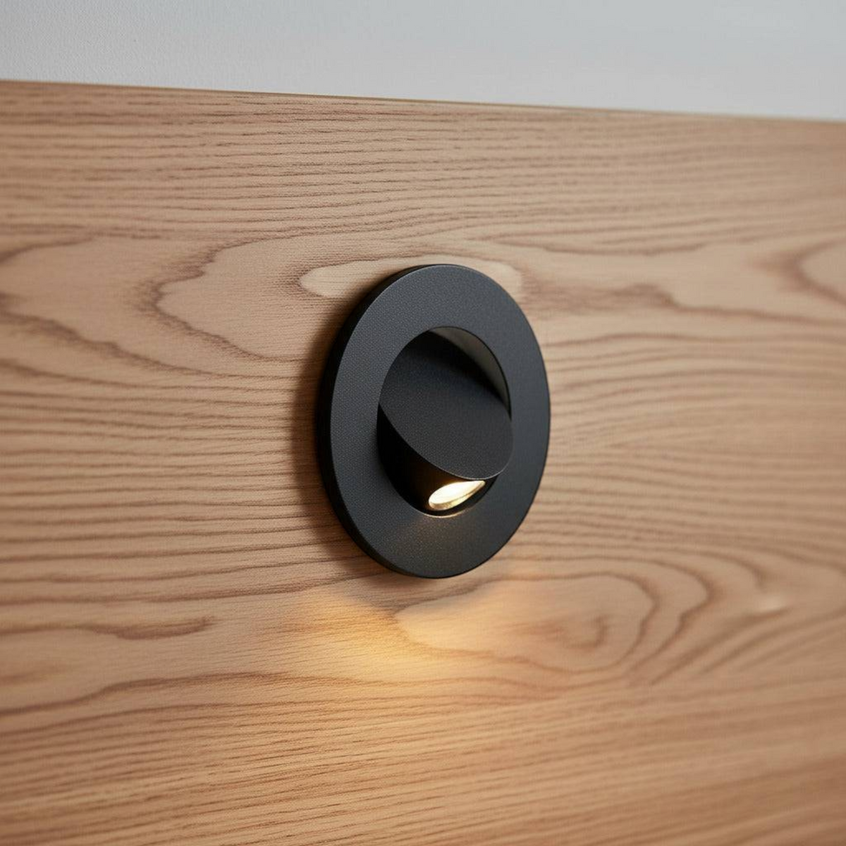 Ultra Beam Lighting Ltd black recessed LED reading light mounted on a wooden headboard with a tilt-and-twist design.