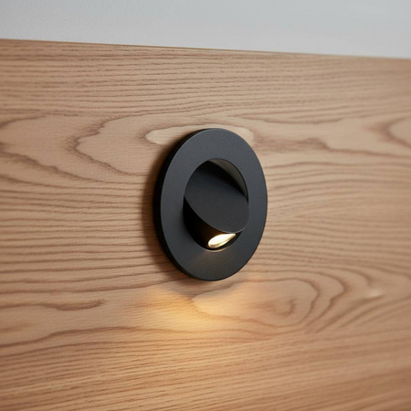 Ultra Beam Lighting Ltd black recessed LED reading light mounted on a wooden headboard with a tilt-and-twist design.