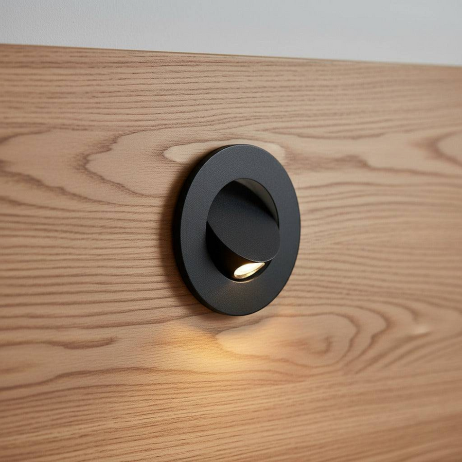 Ultra Beam Lighting Ltd black recessed LED reading light mounted on a wooden headboard with a tilt-and-twist design.