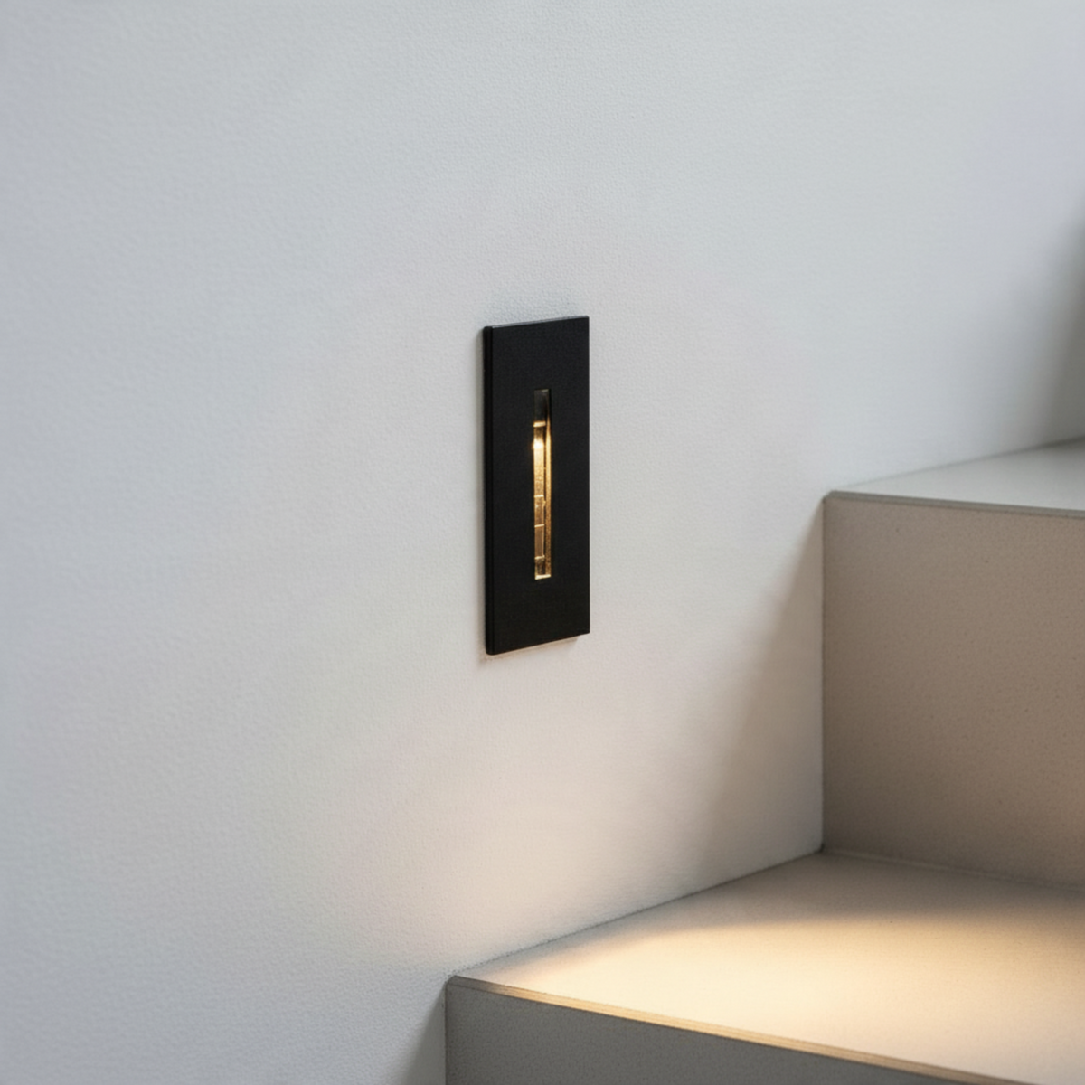 Ultra Beam Lighting Ltd 3W black recessed motion sensor light illuminating a staircase step with warm white light