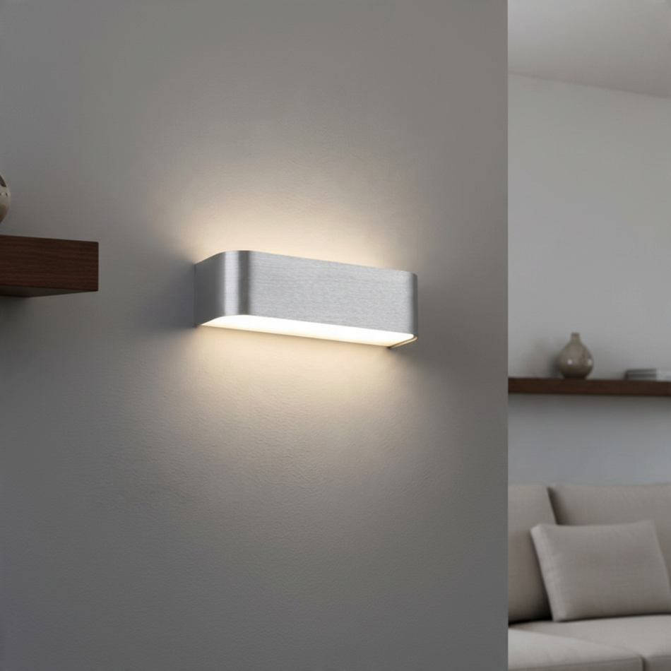 Ultra Beam Lighting Ltd brushed aluminium up and down LED wall light casting warm light on a modern interior wall.