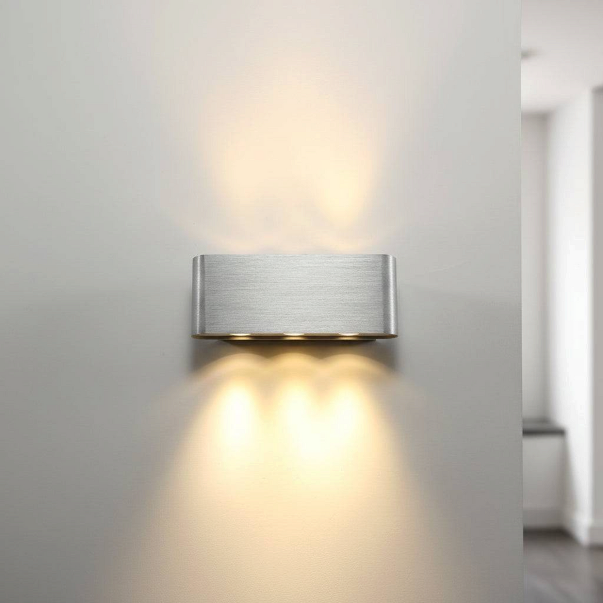 Ultra Beam Lighting Ltd brushed aluminium wall light with up and down warm white LED illumination on a grey wall