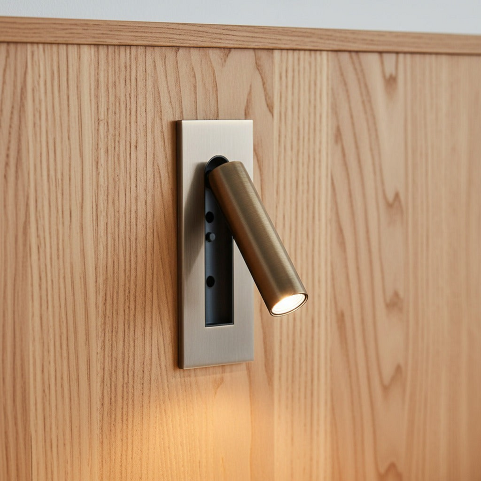 brushed copper recessed adjustable bedroom reading light mounted on a wooden headboard