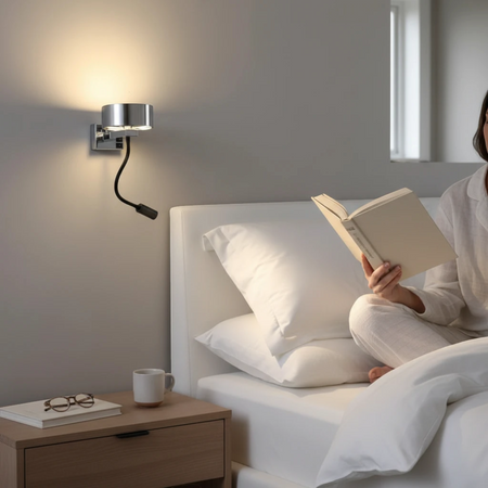 Ultra Beam Lighting Ltd polished chrome bedside wall lamp with a flexible black LED reading arm in a bedroom setting.
