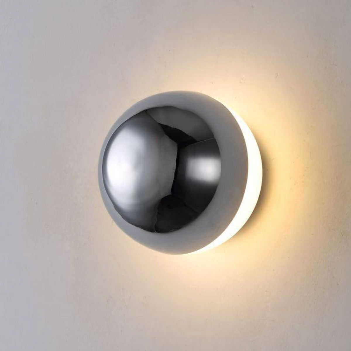 Ultra Beam Lighting Ltd 6W chrome dome wall light with an acrylic diffuser creating a warm halo effect on a wall.
