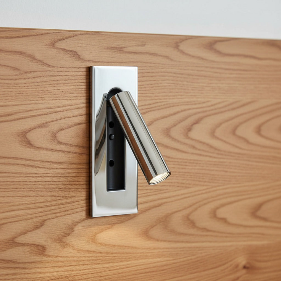 chrome recessed adjustable LED reading wall lamp mounted on a wooden bed headboard