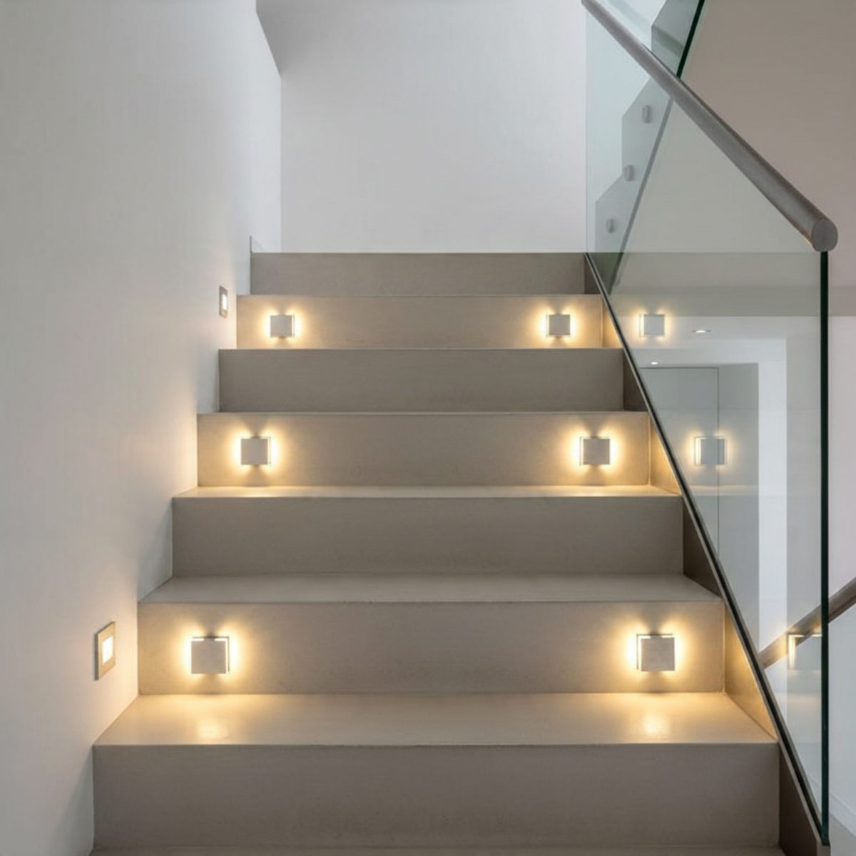Ultra Beam Lighting Ltd Halo square 1W LED recessed stair lights in brushed aluminum installed on a modern staircase.
