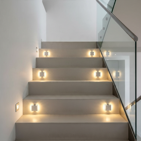 Ultra Beam Lighting Ltd Halo square 1W LED recessed stair lights in brushed aluminum installed on a modern staircase.