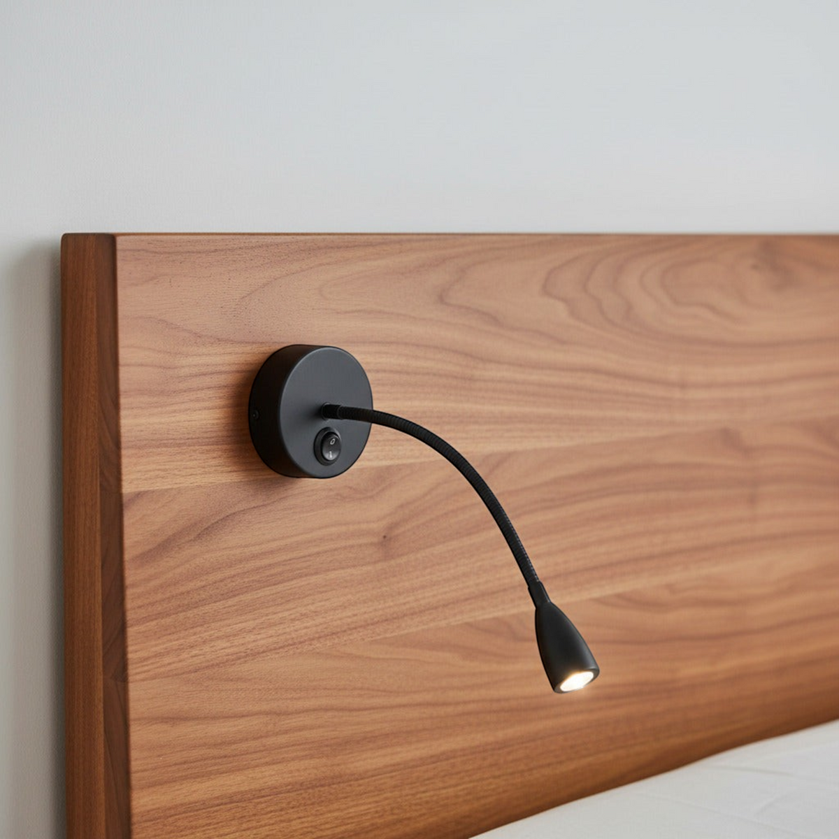 Ultra Beam Lighting Ltd Nero black LED gooseneck reading light mounted on a wooden headboard