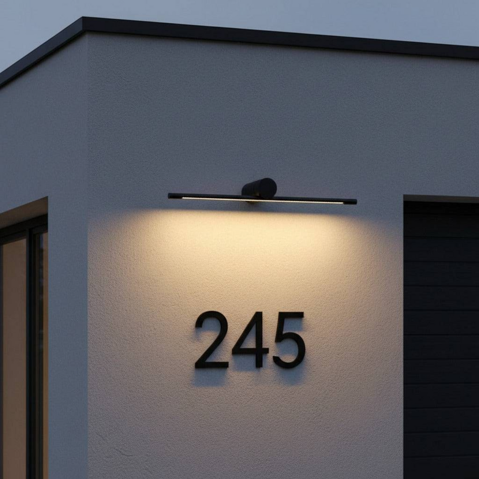 Ultra Beam Lighting Ltd 8W LED outdoor sign light in black, mounted above house number 245 on a modern exterior wall.