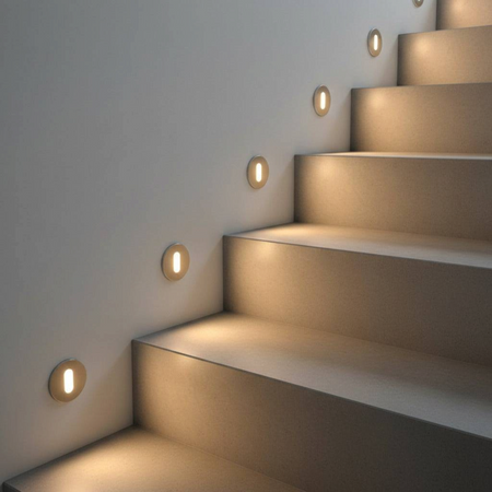 Ultra Beam Lighting Ltd round 1 watt recessed LED step lights in brushed aluminium installed along a staircase wall