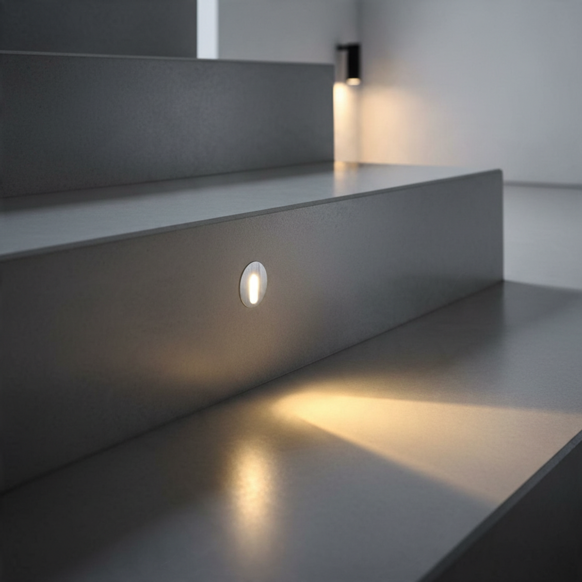 Ultra Beam Lighting Ltd round 1 watt recessed LED step light in brushed aluminium installed on a modern staircase