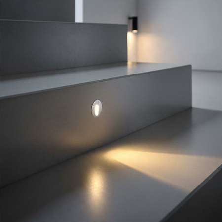 Ultra Beam Lighting Ltd round 1 watt recessed LED step light in brushed aluminium installed on a modern staircase
