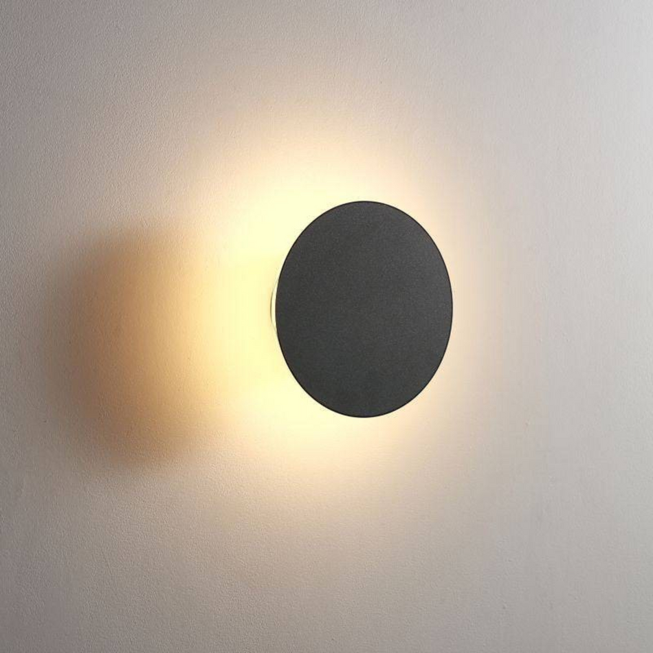Ultra Beam Lighting Ltd 6W round black bathroom sconce with warm 3000K LED glow and IP65 moisture-resistant rating.
