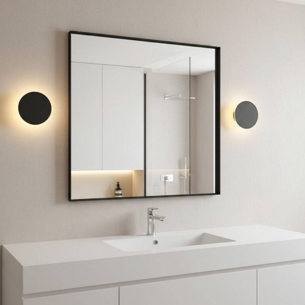 Ultra Beam Lighting Ltd round black bathroom sconce with warm LED light mounted on a modern vanity wall.