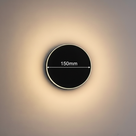 Ultra Beam Lighting Ltd 12W round black LED outdoor wall lamp with a 150mm diameter and warm halo glow effect.
